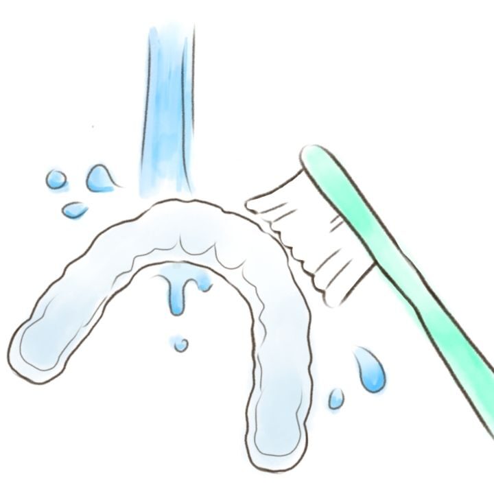 ナイトガードを流水とブラシで洗っているイラスト